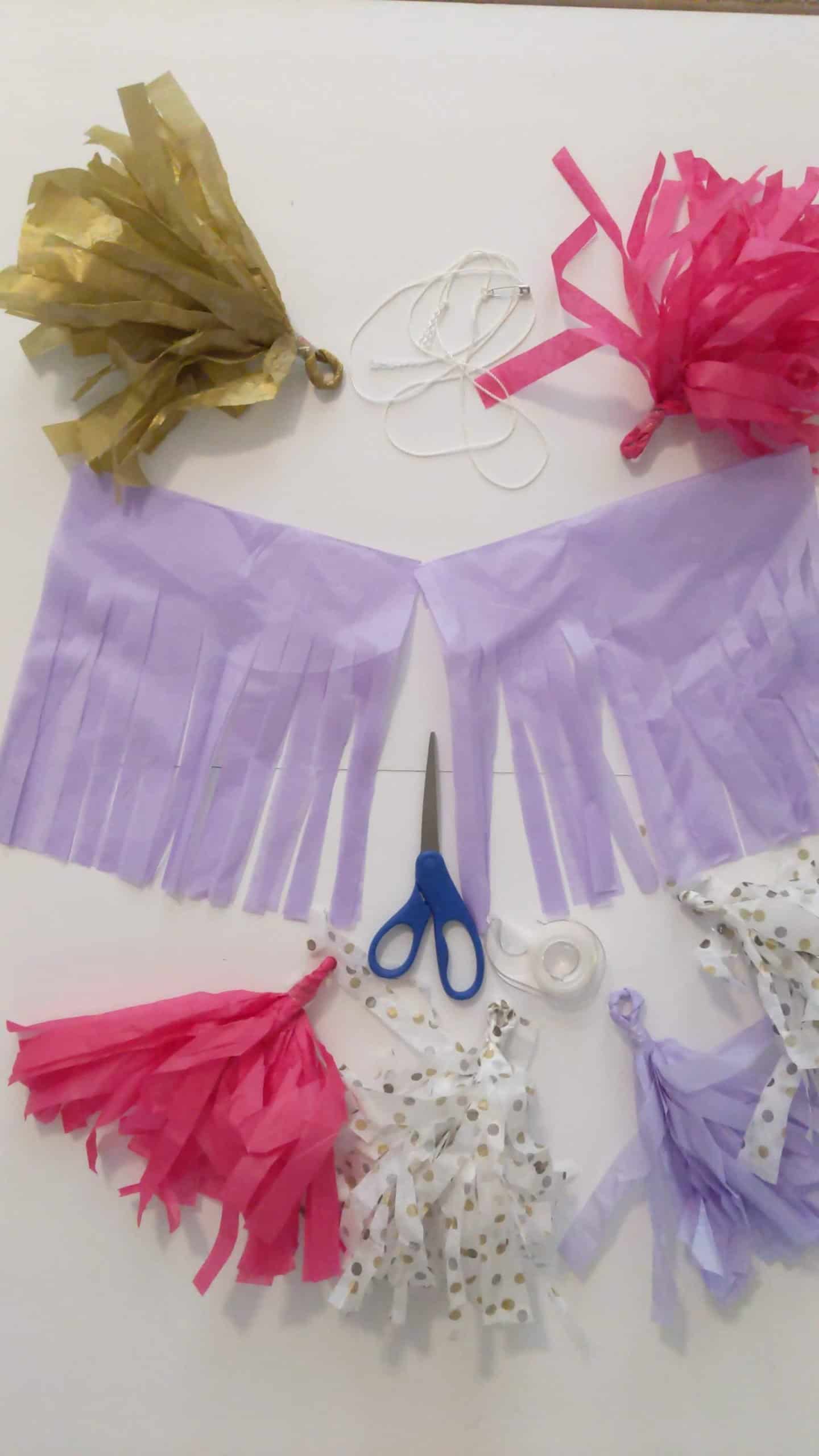 After you cut the fringe, cut the tissue paper in half, and start to roll it.