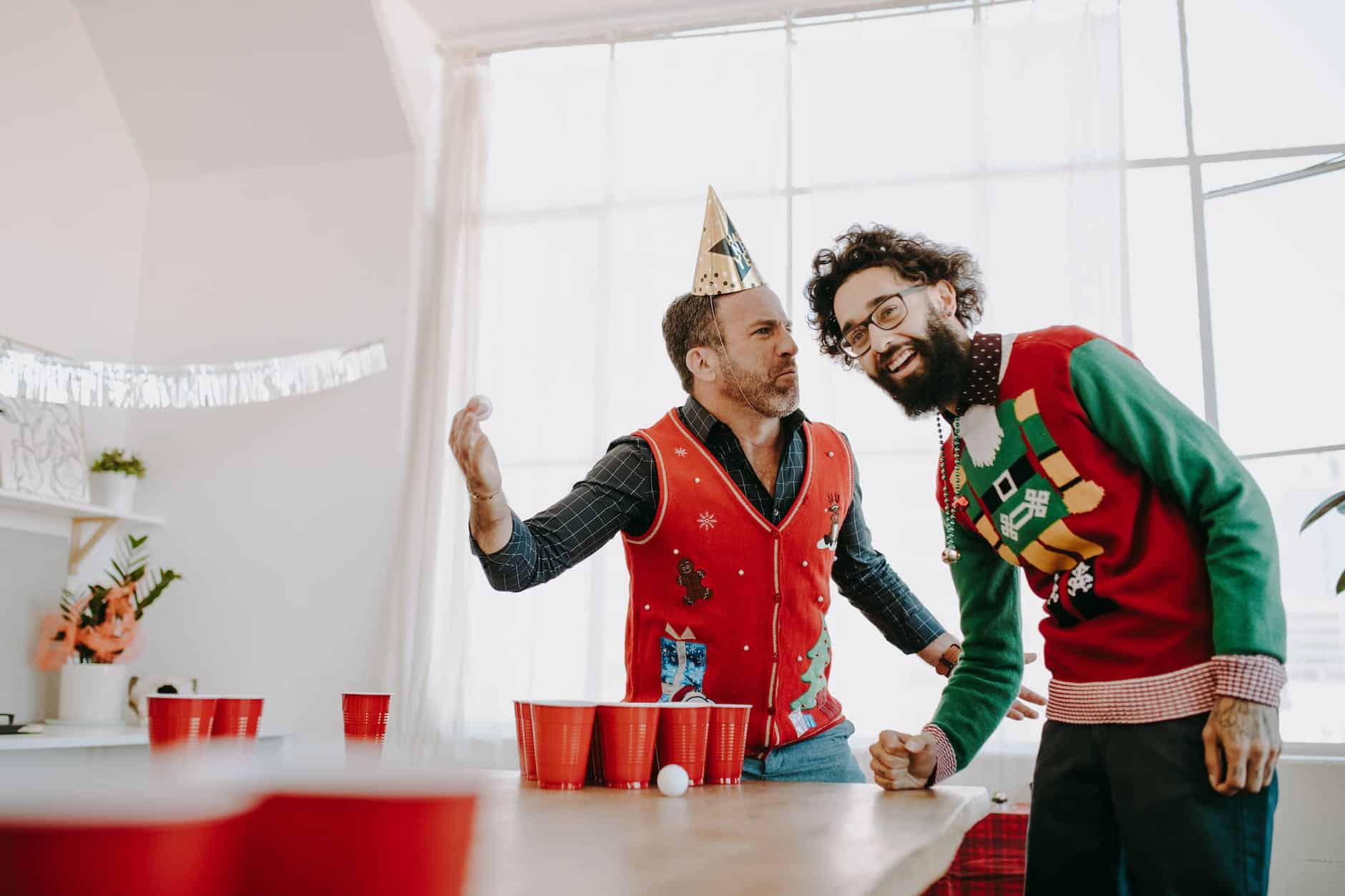 happy colleagues playing beer pong